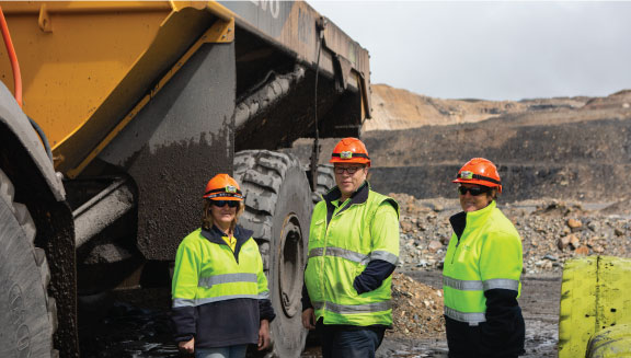 Miners beside truck
